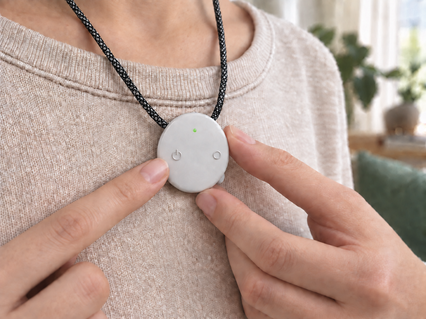 Pressing the power button on a white AMOFIT S Pro worn over clothing